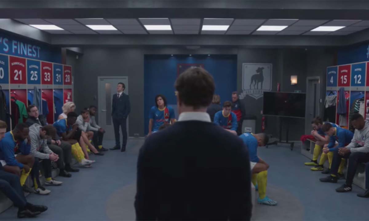 Lockeroom scene in Ted Lasso where Ted’s back is visible